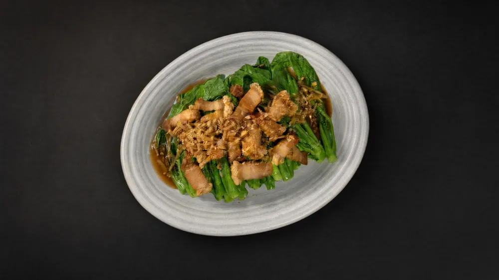 Thai Bistro crispy pork belly over stir-fried Chinese broccoli