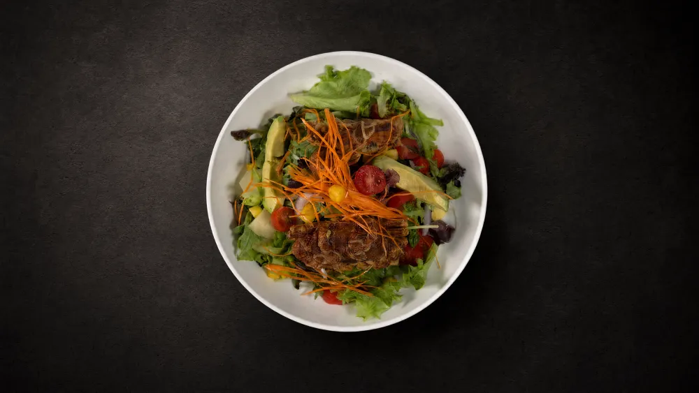 Thai Bistro grilled steak salad with avocado, cherry tomatoes and mixed greens