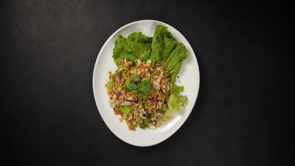 Thai Bistro larb-style rice salad served in lettuce cups with herbs and red onion