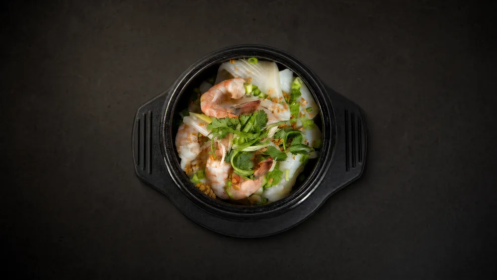 Thai Bistro shrimp and glass noodles in a claypot with garlic and cilantro