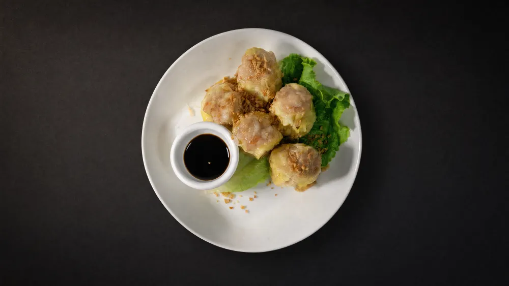 Thai Bistro steamed pork dumplings with crispy garlic and soy dipping sauce